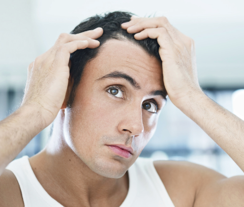 Man looking at hair